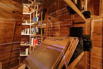 <p>Edgar Arceneaux (U.S., born 1972). <i>Library of Black Lies.</i> 2016 .Wood, mirrored glass, mylar, newspaper, hard-bound books, sugar crystals, lighting fixtures, audio component. Courtesy of the artist. [installation view <i>in Edgar Arceneaux: Library of Black Lies</i>, Henry Art Gallery, University of Washington, Seattle. 2018]. Photo: Mark Wood.</p>
